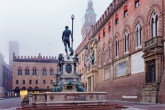 Bologna - Fontana di Nettuno or Neptune fountain on Piazza Maggiore square and Palazzo Comunale in fogy morning